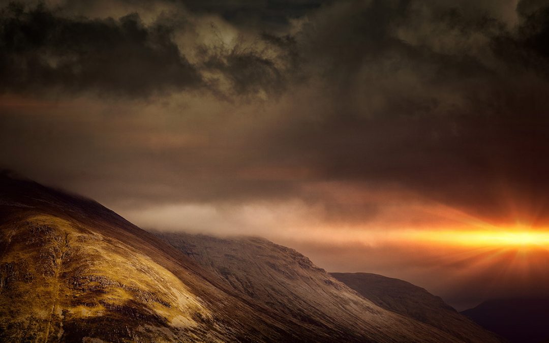 Sun Peaking Behind Mountains